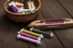 weaving bobbins wound with different colors of cotton
