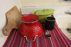 dishes drying on a towel by the sink